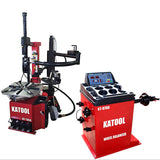 The red Katool T850 tire changer and B700 wheel balancer are showcased together as a powerful, coordinated unit. The tire changer, with its integrated assist arm, stands next to the balancer, which features a protective hood, both positioned in a professional workshop setting.
